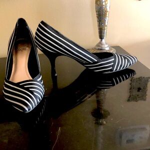 Striped pumps with small Nick on one heel.
Very unique pattern